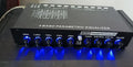 Black car audio equaliser with control knobs for subwoofer volume and frequency adjustment
