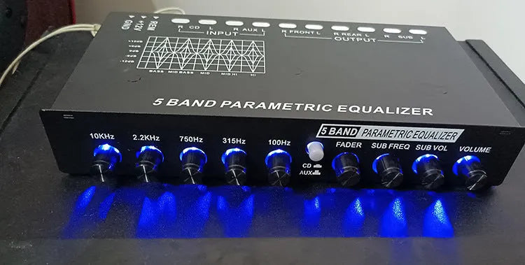Black car audio equaliser with control knobs for subwoofer volume and frequency adjustment