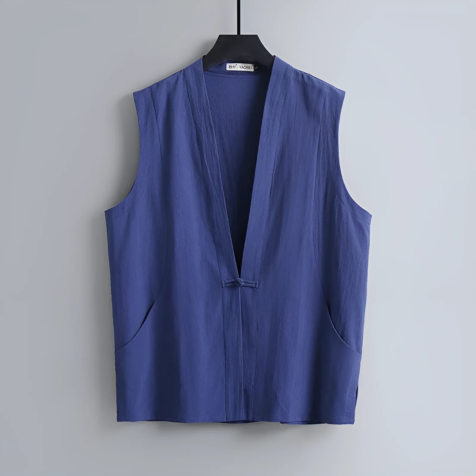 Men's grey linen sleeveless vest with a loose fit on a hanger