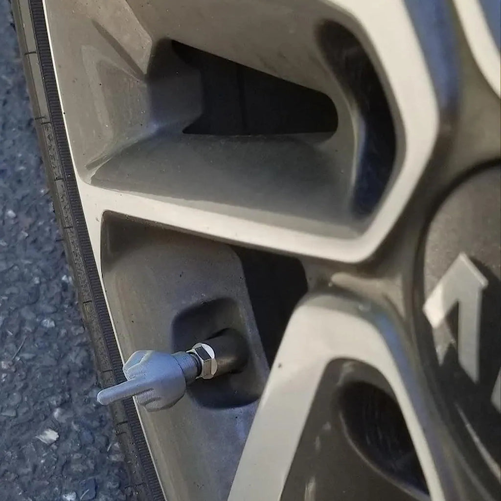 Four latex tyre valve dust caps, two black and two skin colour, for car tyre protection.
