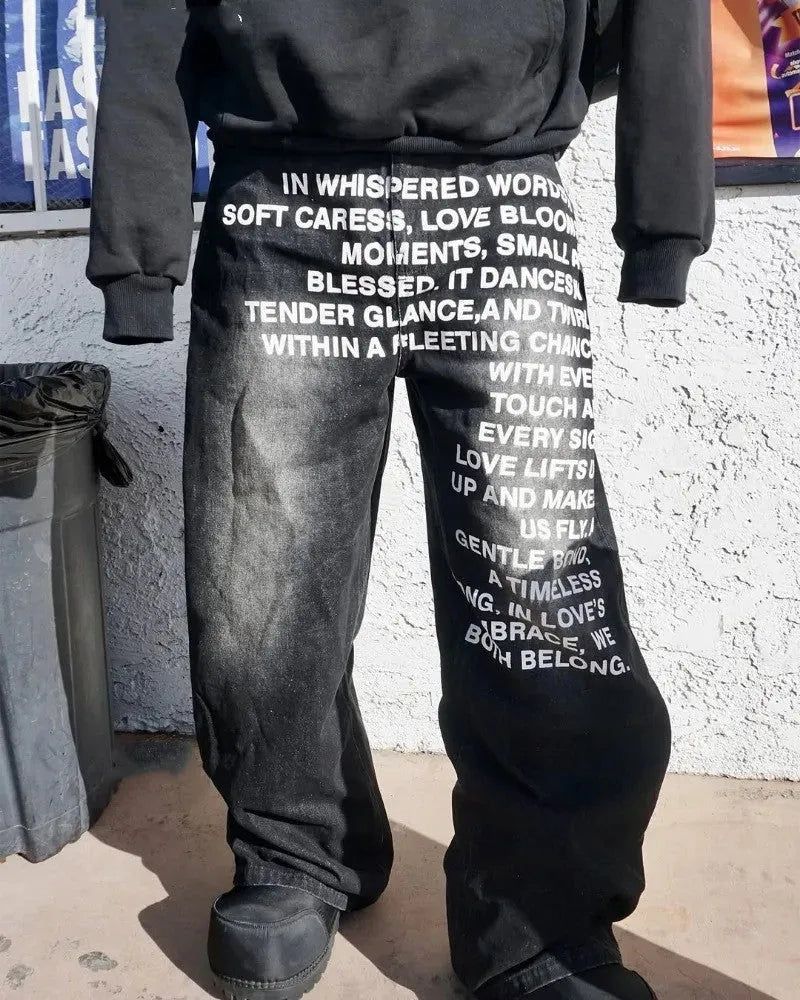 Men's black cotton wide-leg straight trousers with elastic waistband showing loose fit design