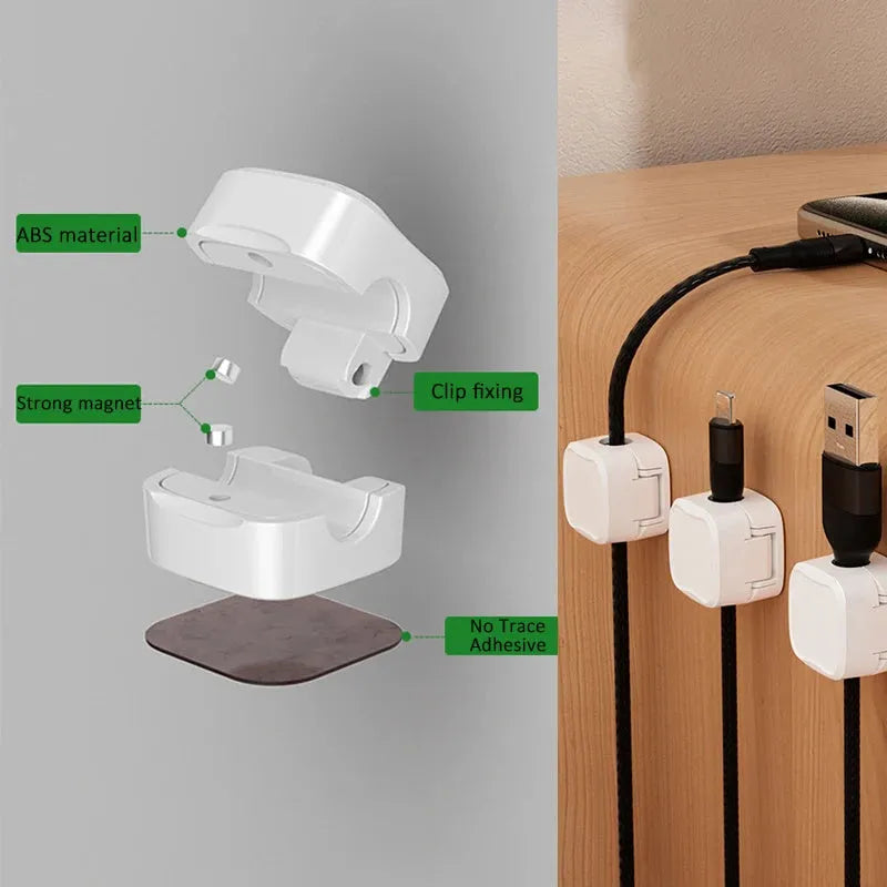 White and black magnetic under-desk cable clips organising various cables with adhesive backing