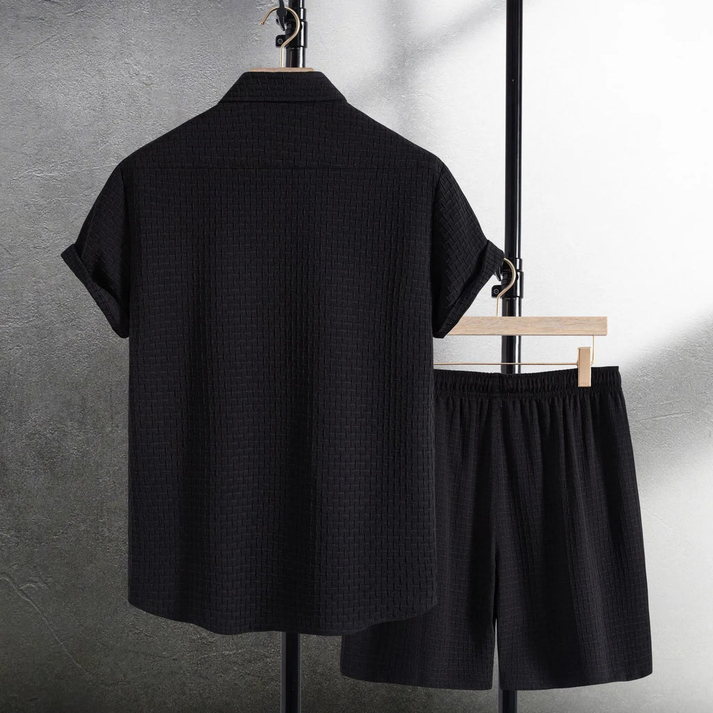 Men's black cotton blend short sleeve shirt and shorts casual suit set on a white background.