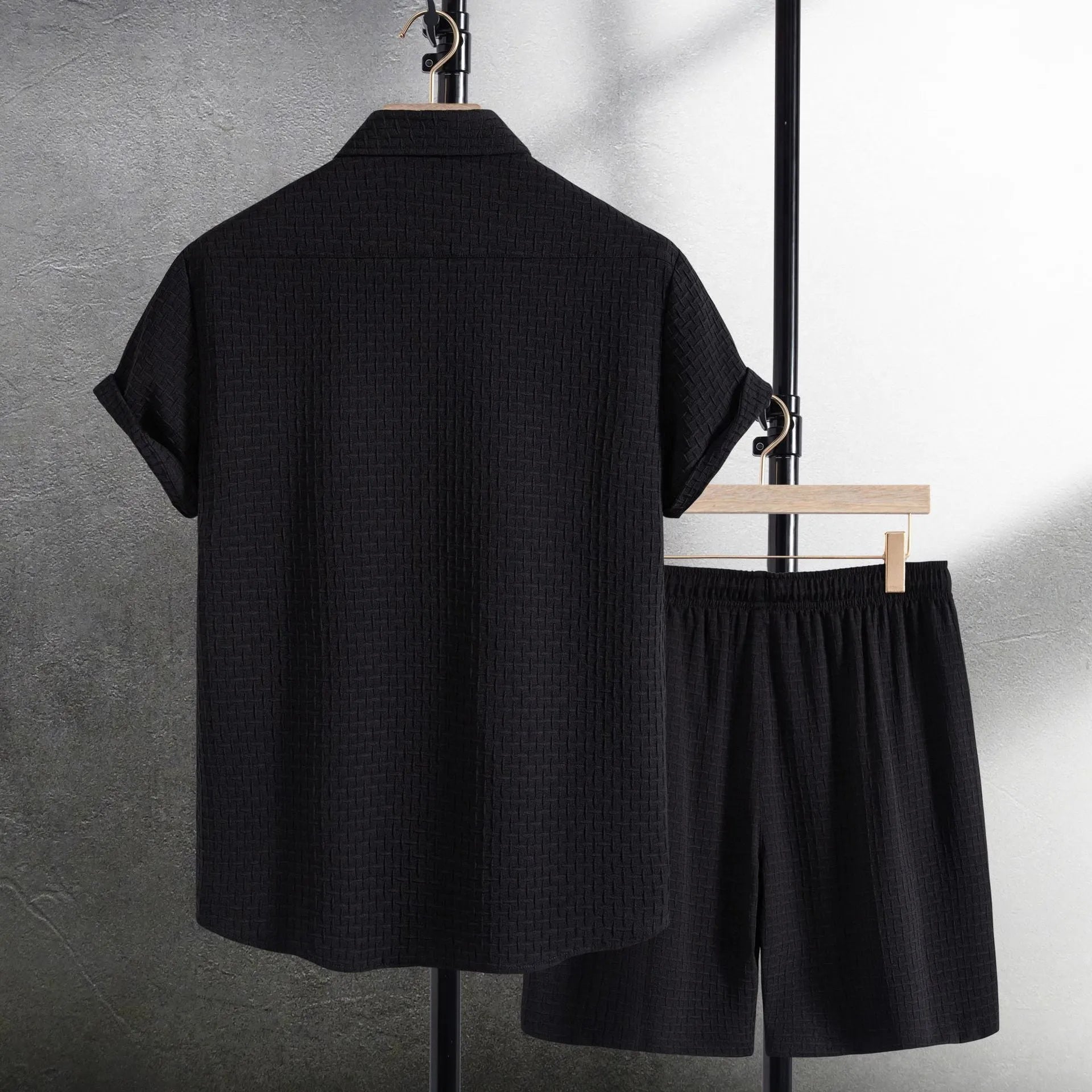 Men's black cotton blend short sleeve shirt and shorts casual suit set on a white background.