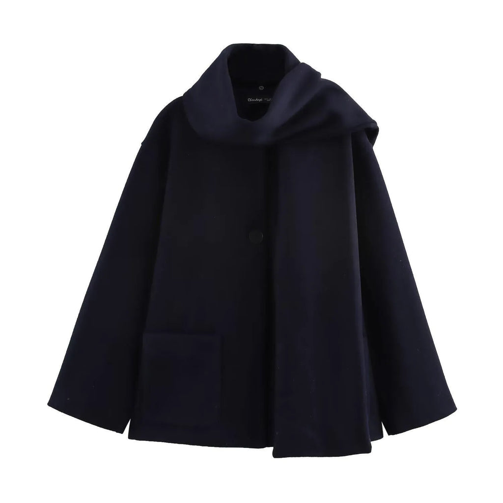 Woman wearing a long black overcoat with a detachable artificial fur collar, styled in a street-fashion look.