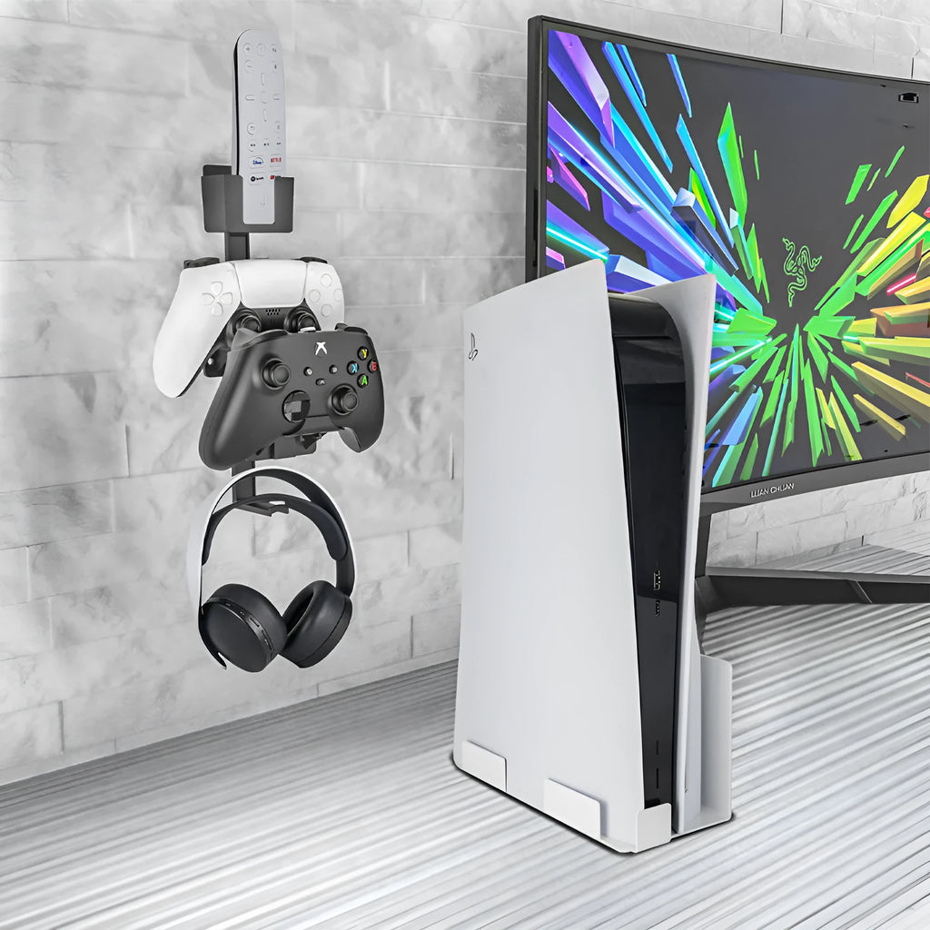 White adhesive wall hook holding a black game controller and a TV remote.