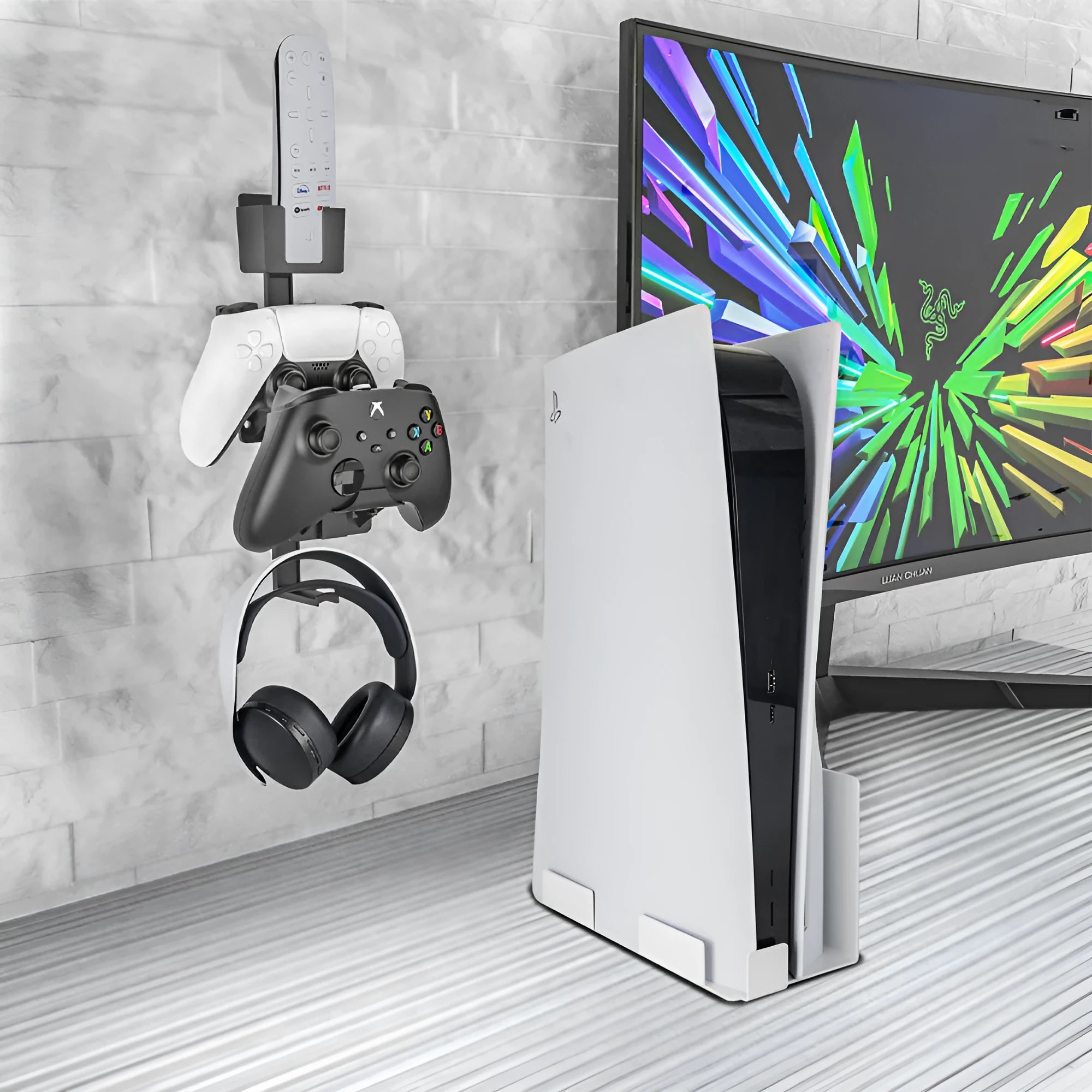 White adhesive wall hook holding a black game controller and a TV remote.