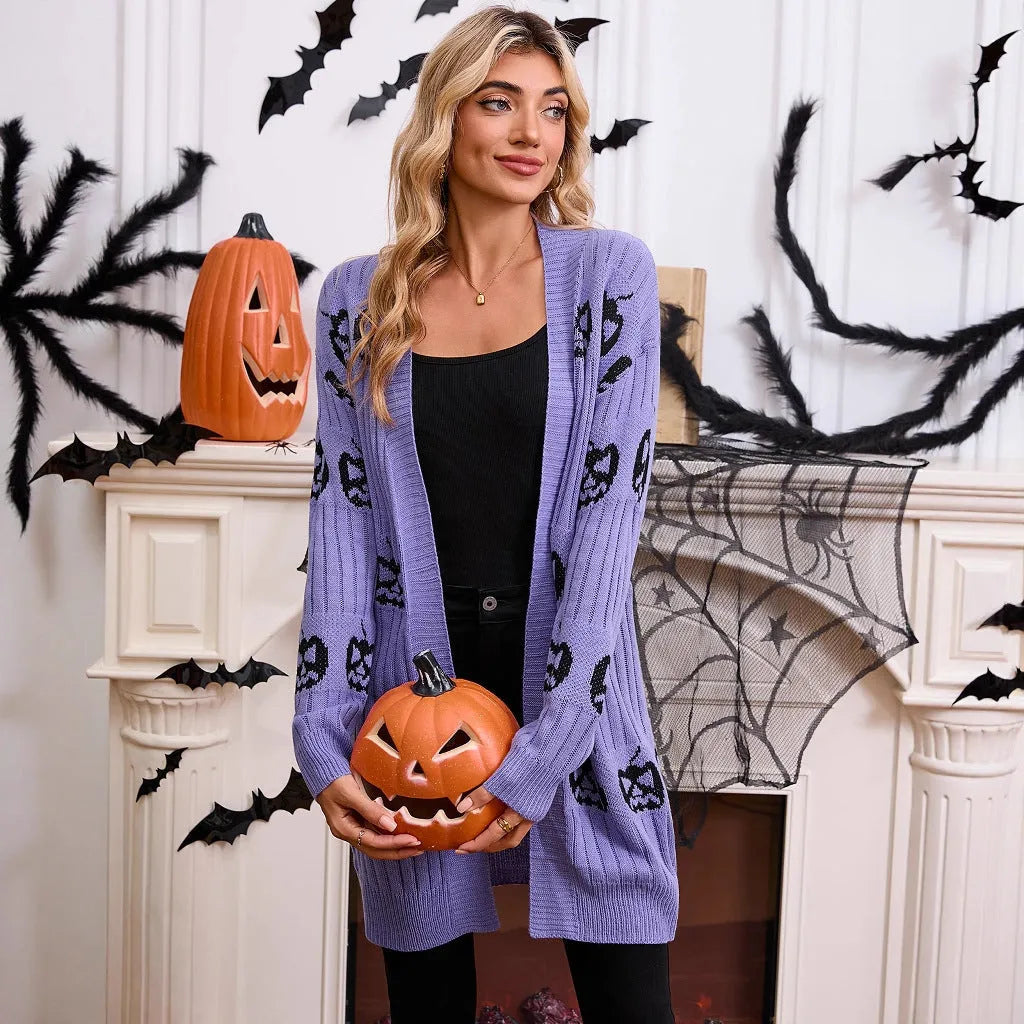 Women's black cardigan with orange pumpkin head jacquard knit pattern on the front.