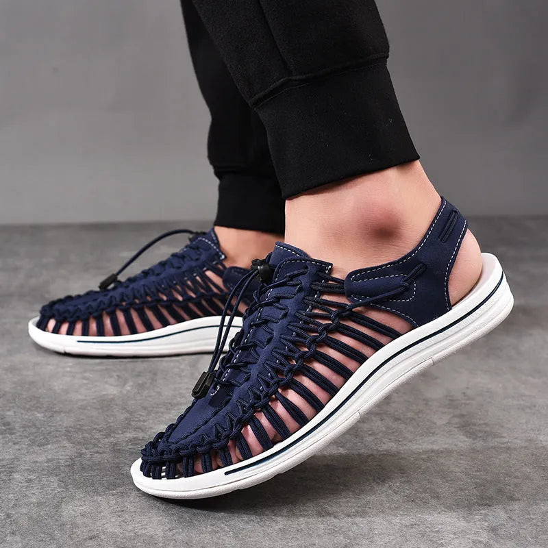 A pair of casual woven Roman sandals with an elastic drawstring tie across the instep.