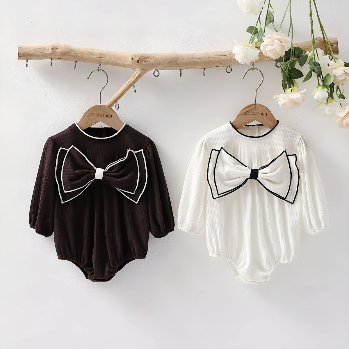 Cotton baby bow long sleeve onesie in black or white, triangle jumpsuit style, sizes 66-100cm