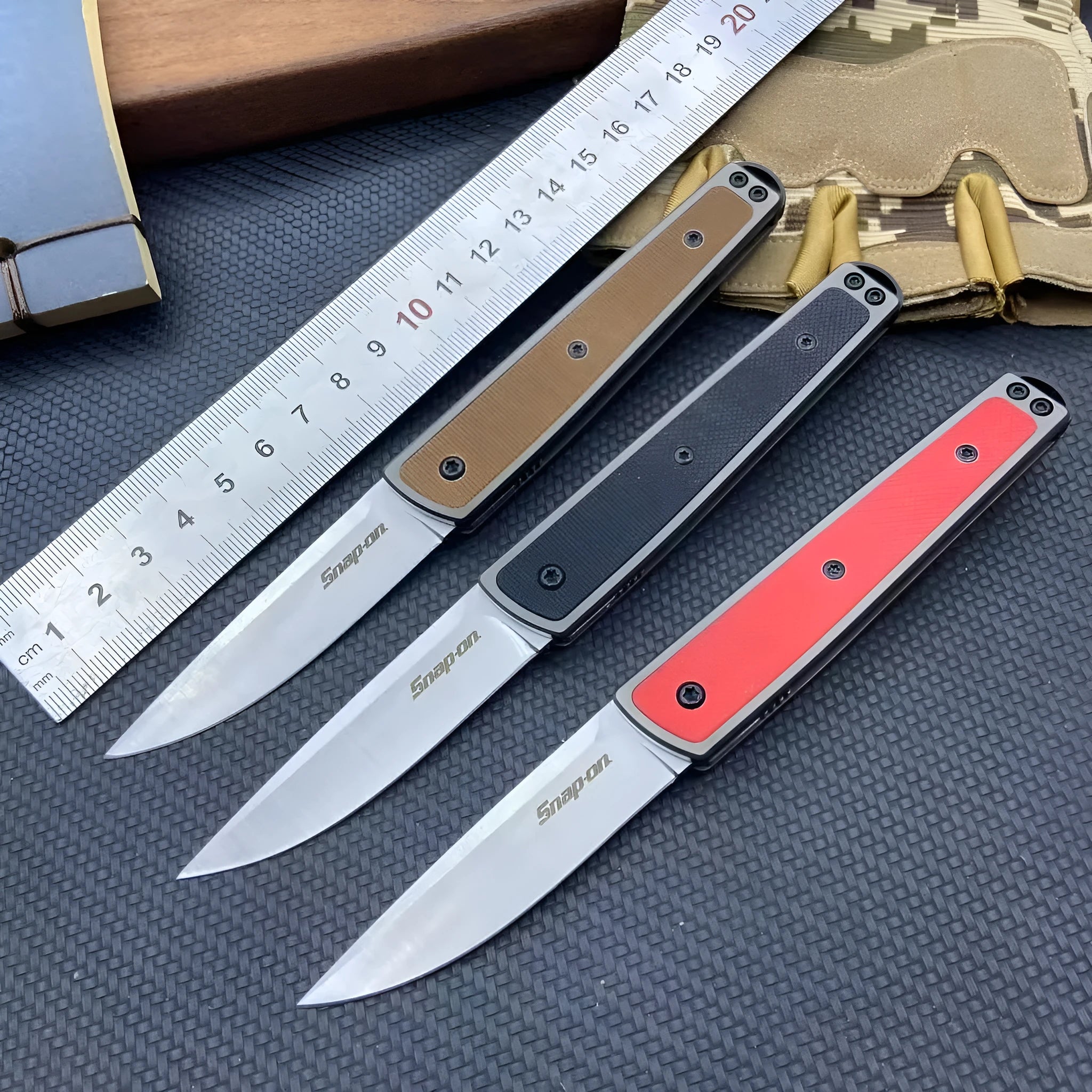 CRKT 7190 folding fruit knife with stainless steel blade shown closed and open, in black, brown, or red colour options.