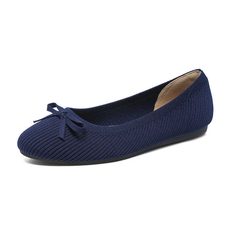 Women's casual flat pumps with fabric upper, butterfly bow, round toe, and flat viscose sole.