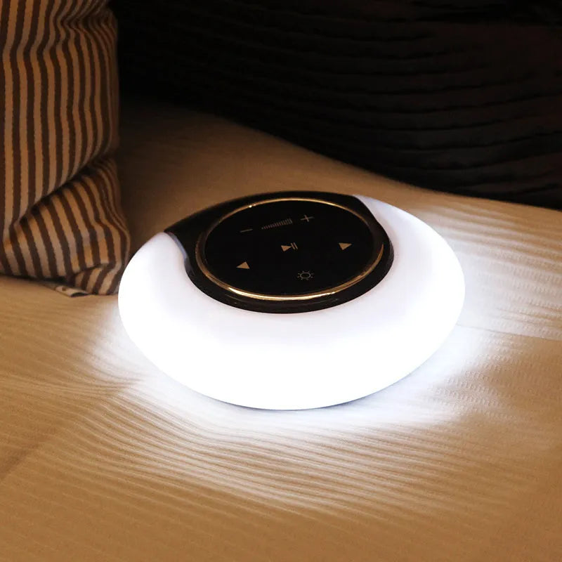 Blue and white Bluetooth speaker desk lamp with touch controls and foldable arms on wooden desk
