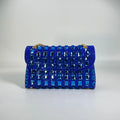 Silver rhinestone chain clutch bag with square shape and internal phone pocket on a table.