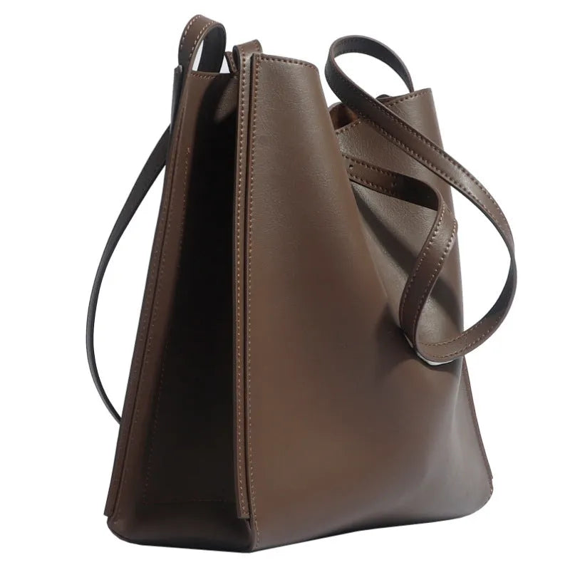 Genuine leather women's bucket bag with shoulder straps showing internal organisation compartments