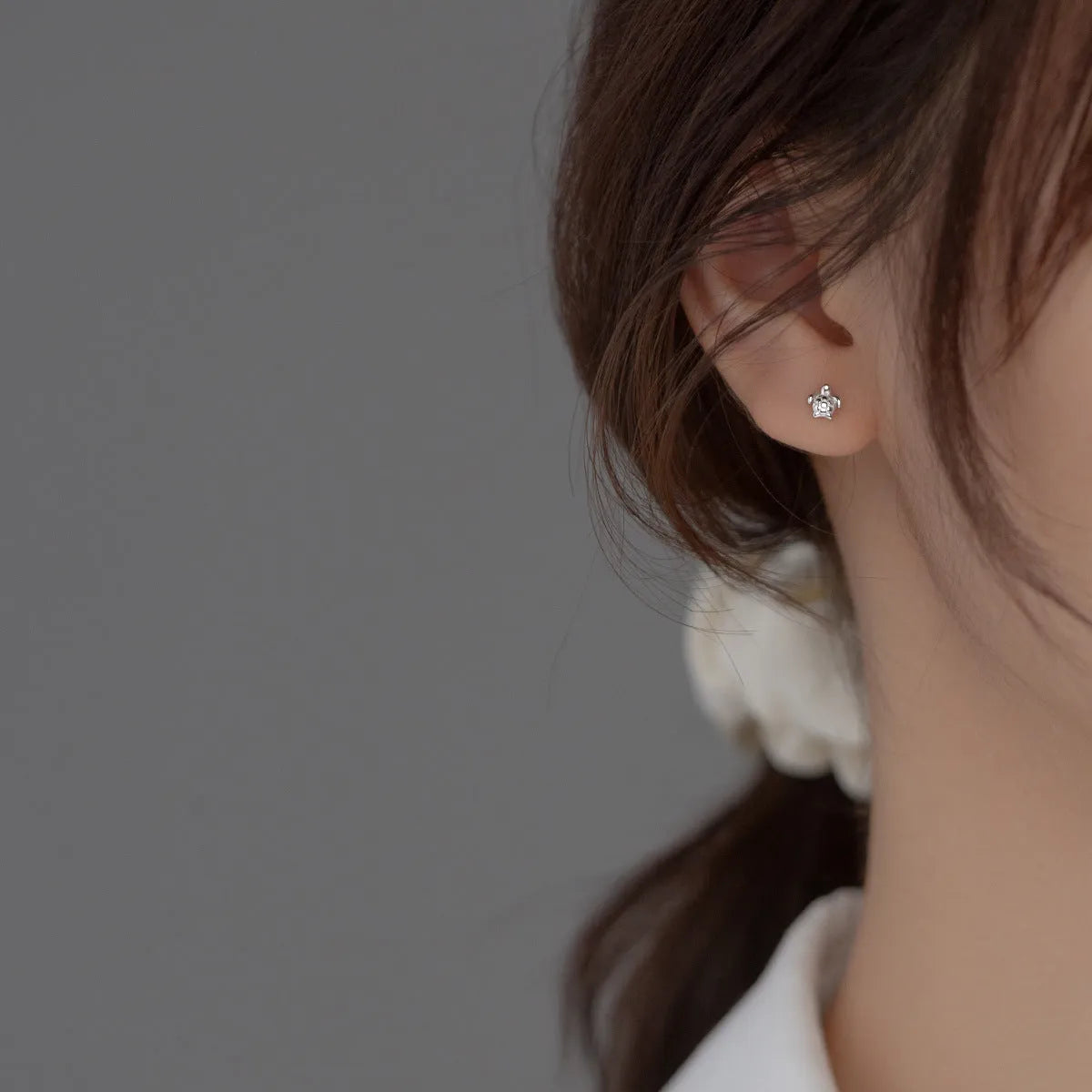 Small 925 sterling silver turtle stud earrings with thread line detail, shown in gold and silver colour options