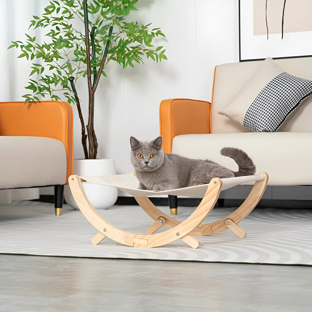 Solid wood foldable cat hammock bed with a neutral cushion on a wooden frame.