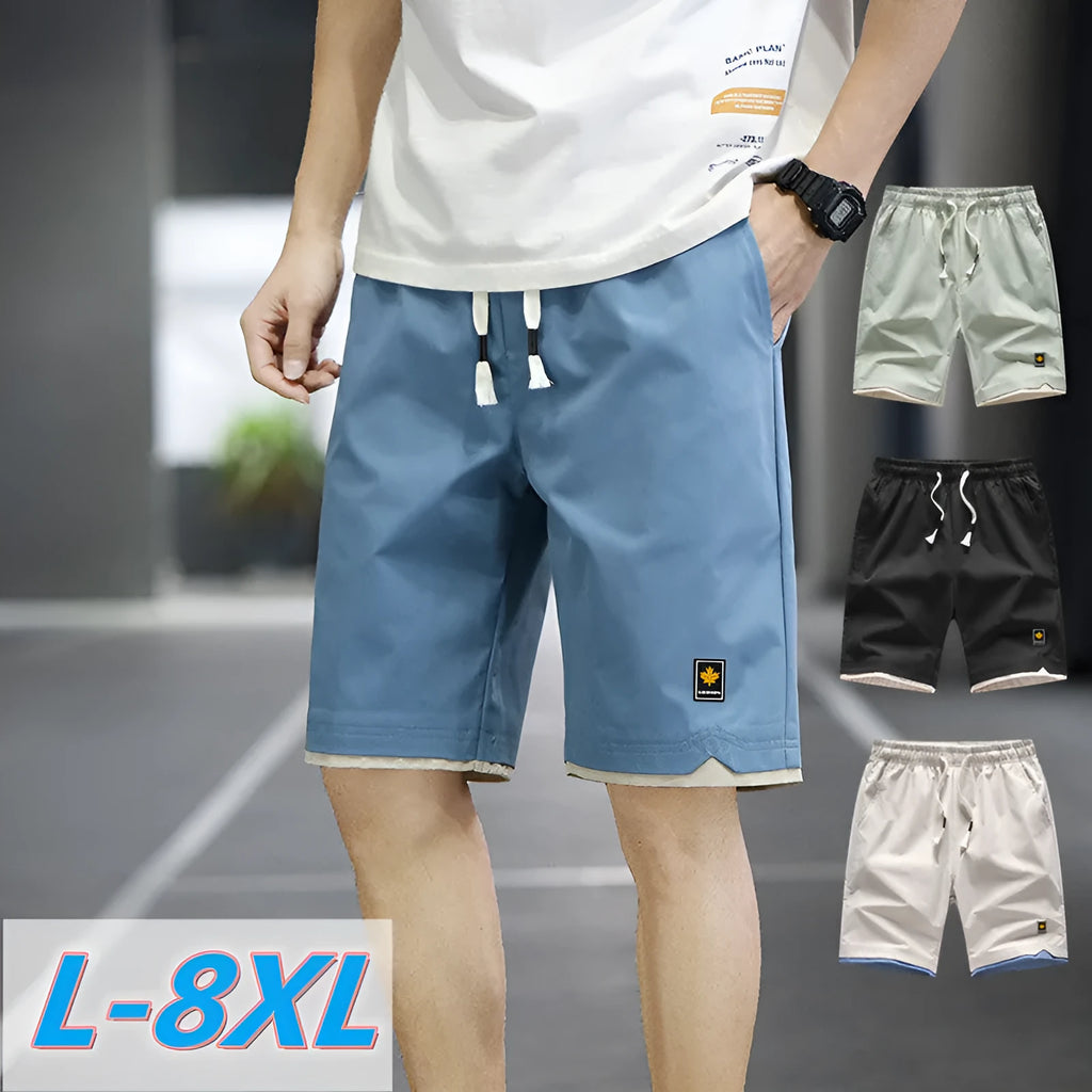 Man's loose fit casual shorts in green, shown flat, highlighting the straight cut and elastic waistband.