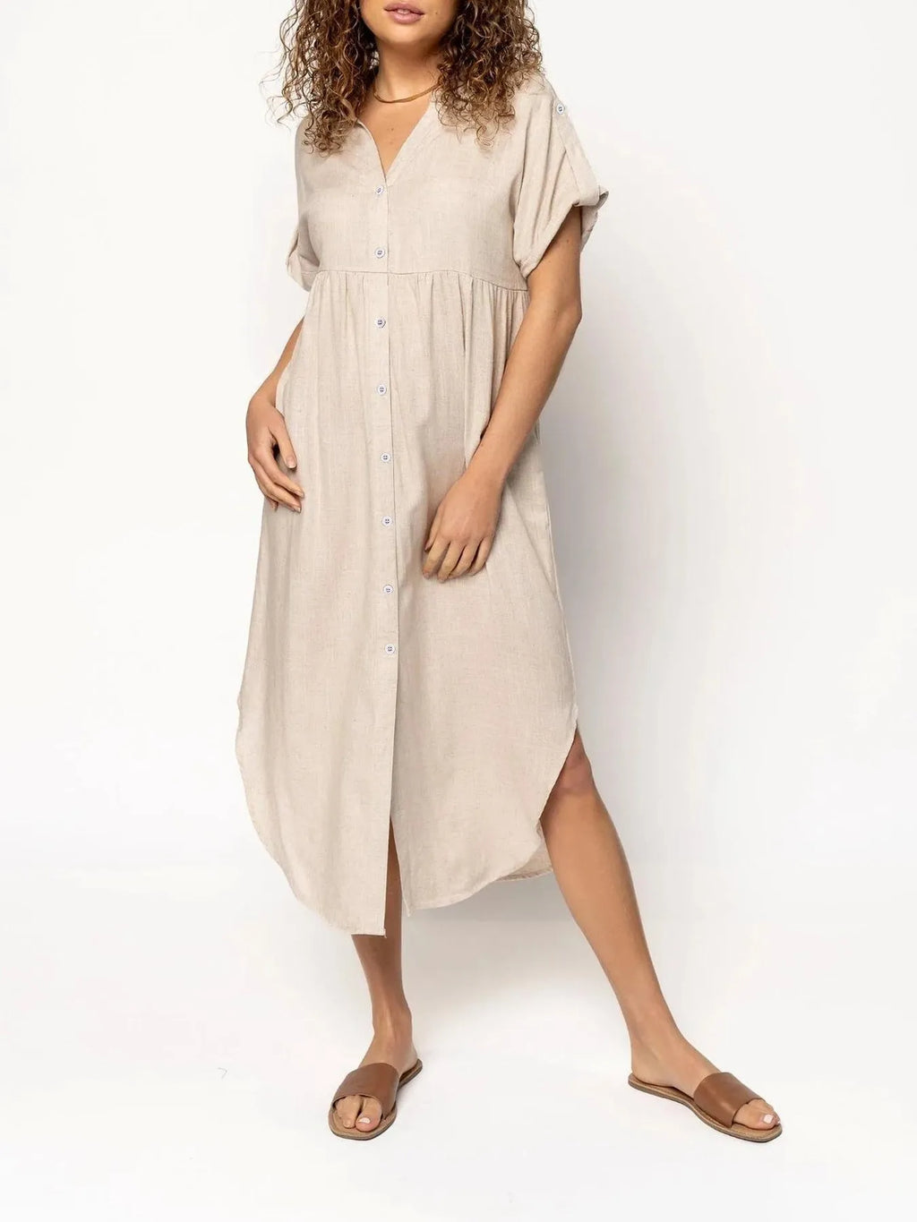 Loose mid-length casual dress in solid colour with button front detail, shown on a hanger.