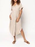 Loose mid-length casual dress in solid colour with button front detail, shown on a hanger.