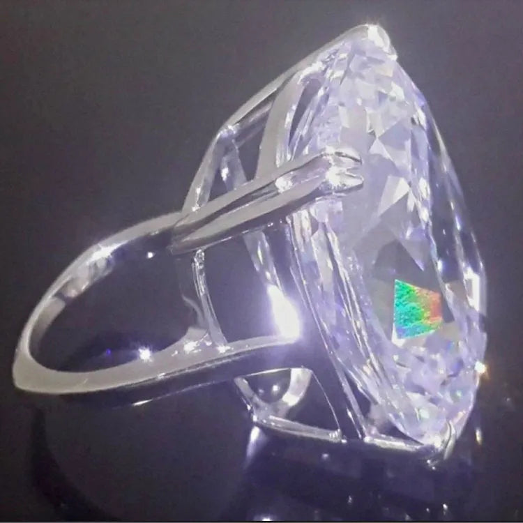 A women's simple inlaid white square diamond ring with a geometric shape and white gold colour finish.