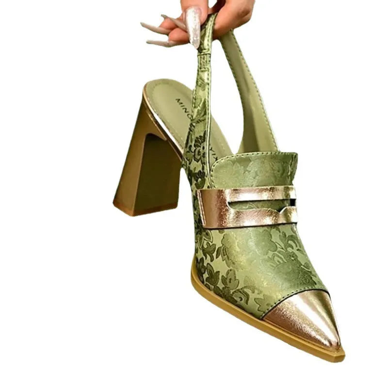 Women's black high heel sandals with chunky heel, pointed toe, and an elastic ankle strap.