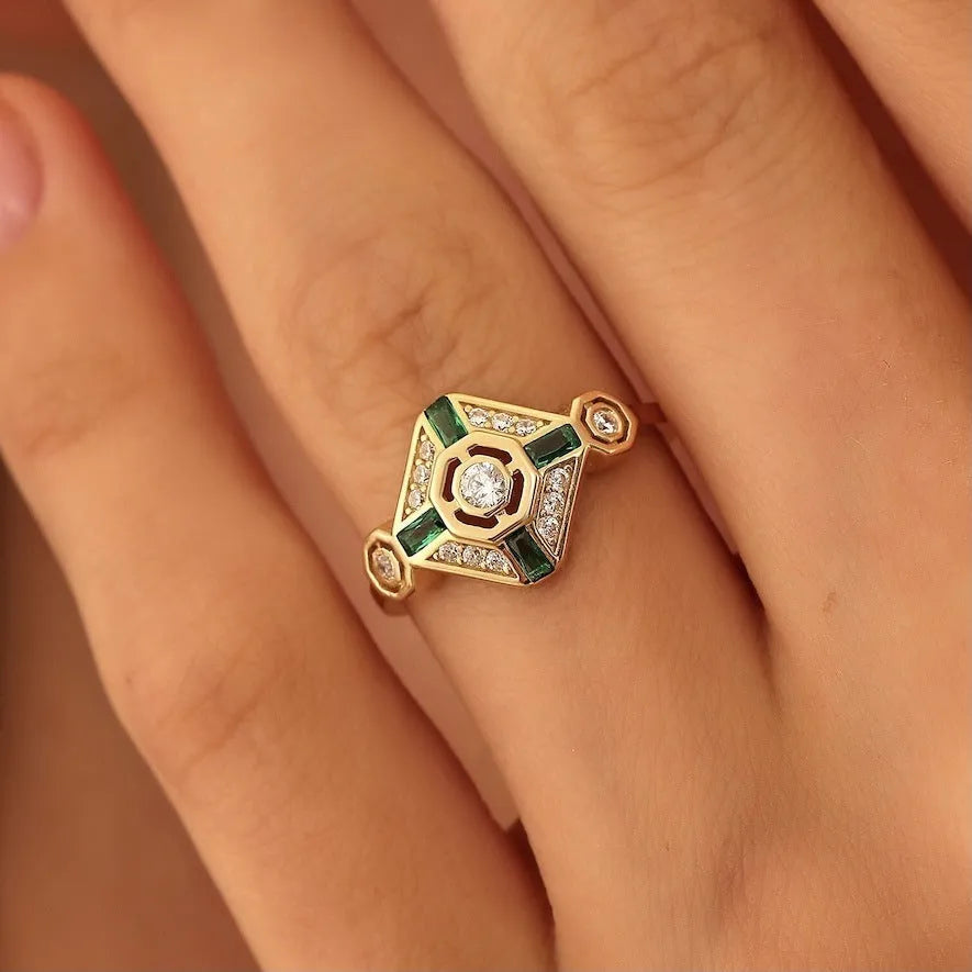 Square-cut emerald green gemstone ring on a finger, showing geometric ins-style design.