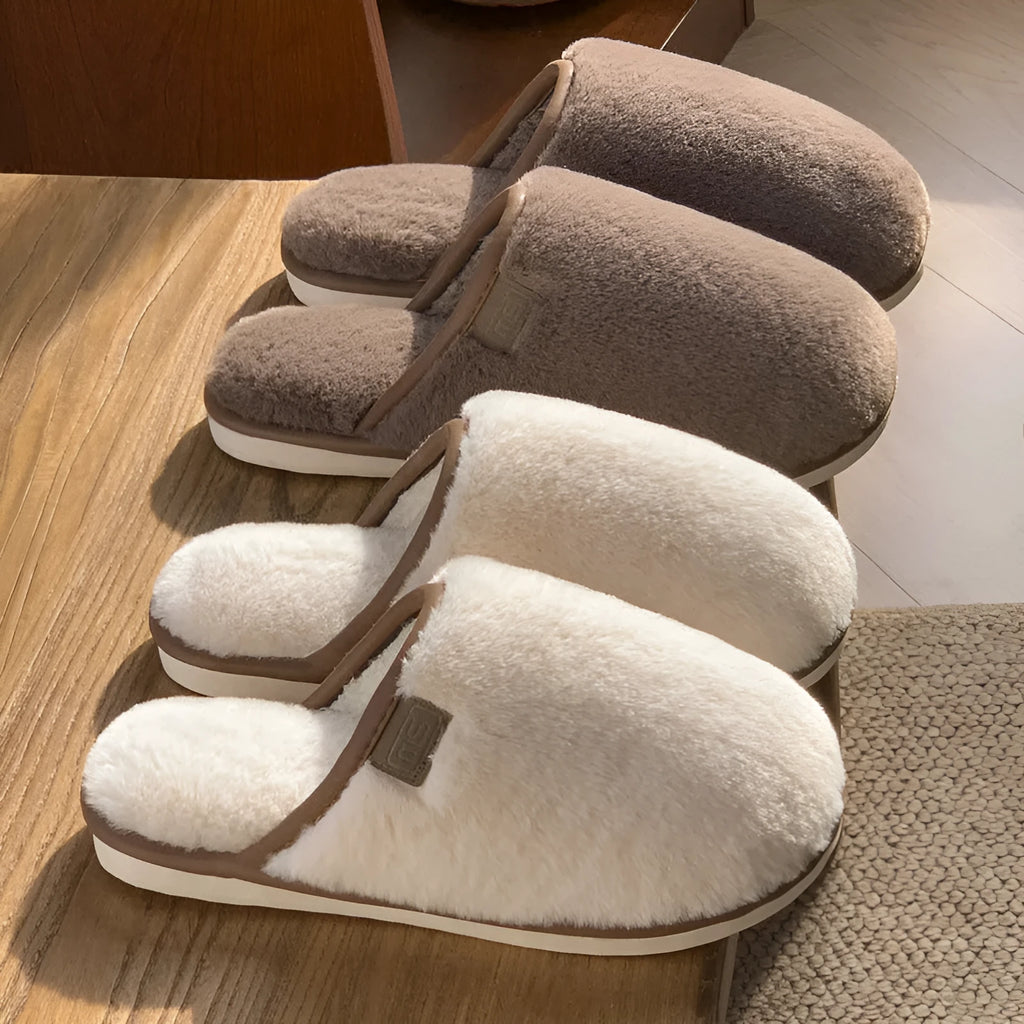 Pair of solid-colour plush winter slippers with a PVC upper and non-slip sole.