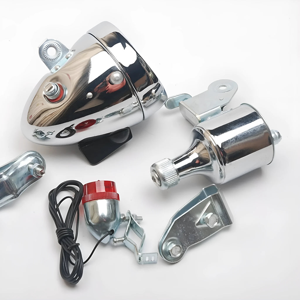 Silver bicycle dynamo generator light kit mounted on a bike frame for friction-powered 12V headlight and tail light