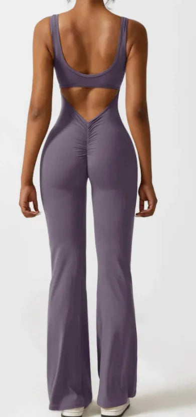Women's black milk silk yoga bodysuit with seamless hollow design and mid waist.