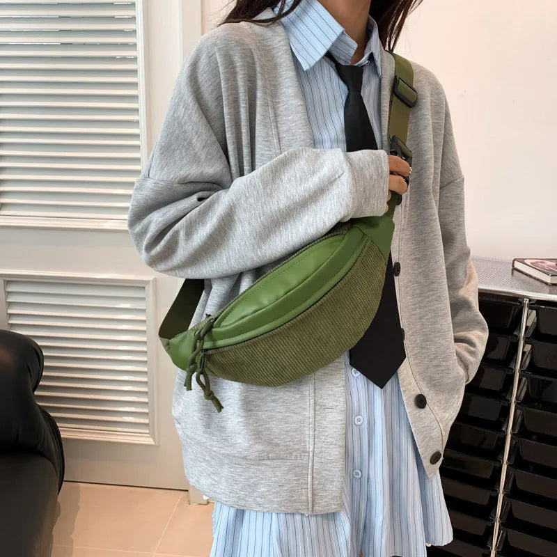 Corduroy crossbody bag in brown with oval shape, slit pocket, and crossbody strap