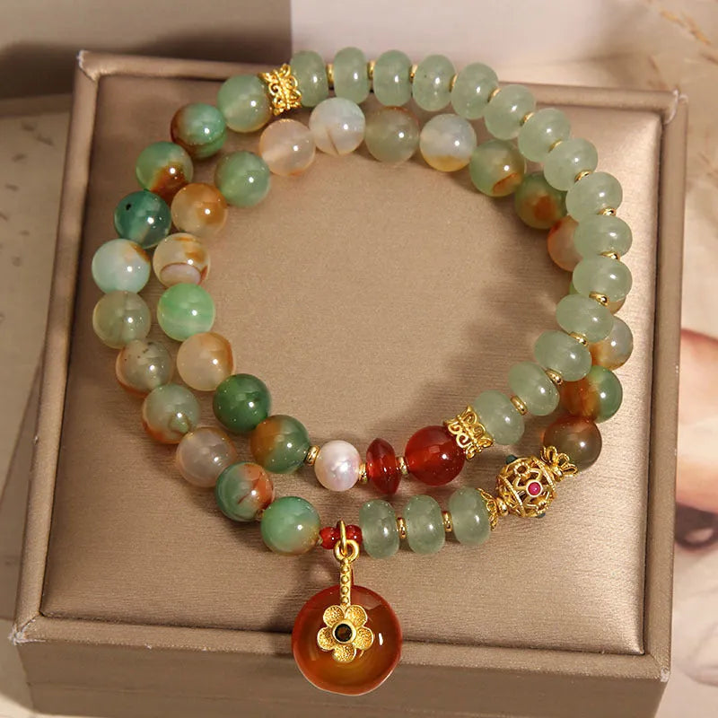 Peacock green agate double ring bracelet for women with safety buckle closure on wrist.