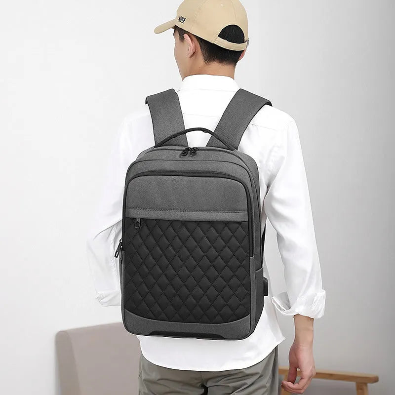 Men's black leisure travel backpack with diamond mesh detail and curved shoulder straps