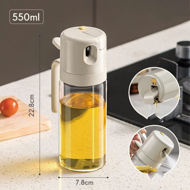 Glass oil sprayer bottle with grey cap, shown in spray and pour modes next to cooking ingredients.