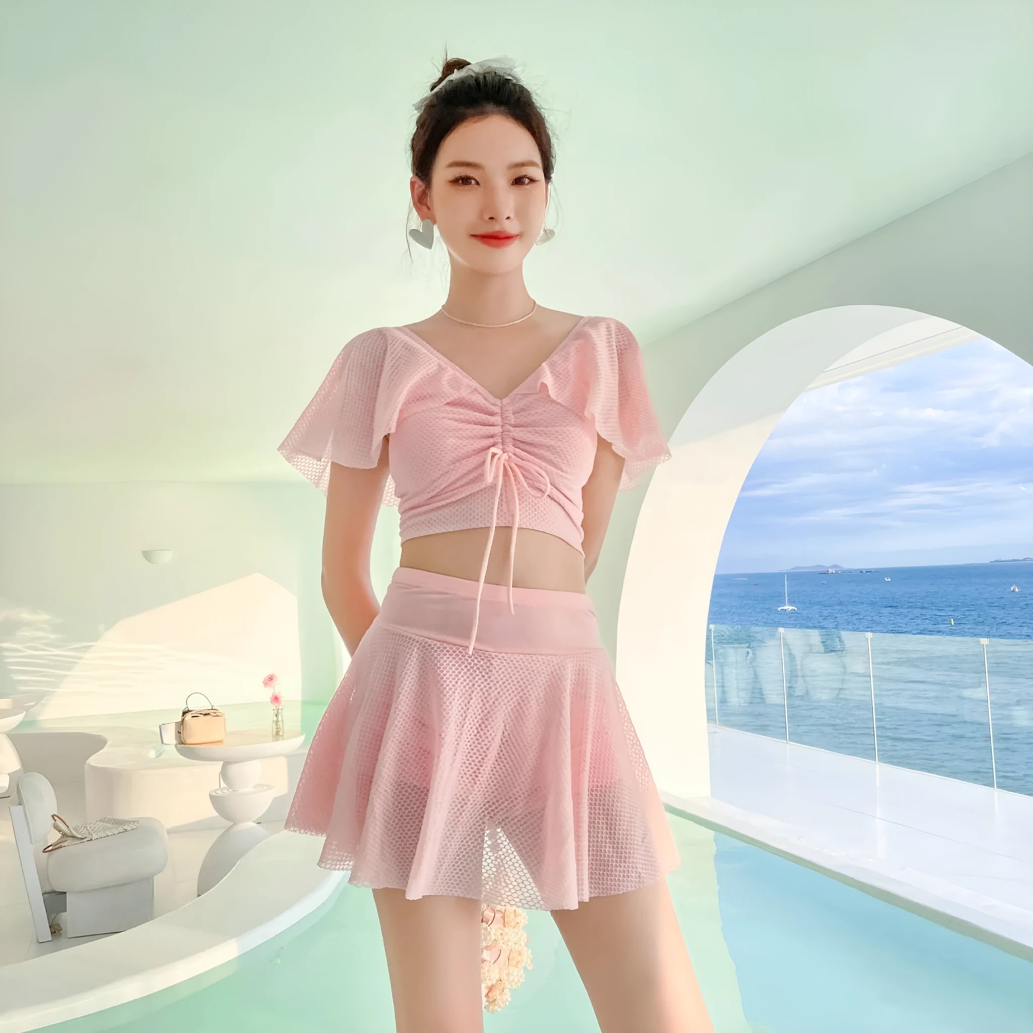 Women's two-piece swimwear set with matching top and skirt in solid colour