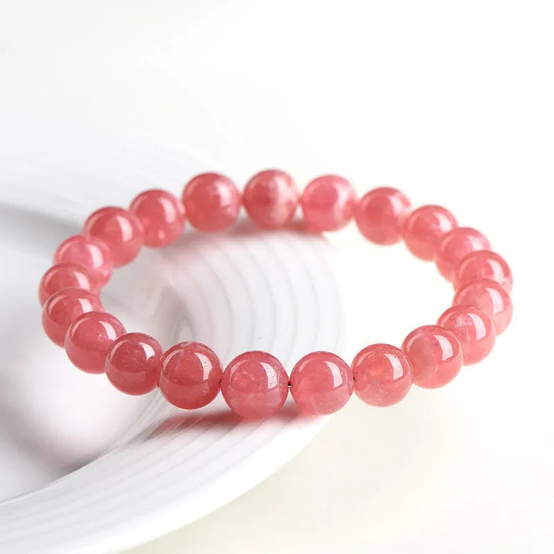 Geometric red crystal women's bracelet with a longevity lock fastening on a wrist.