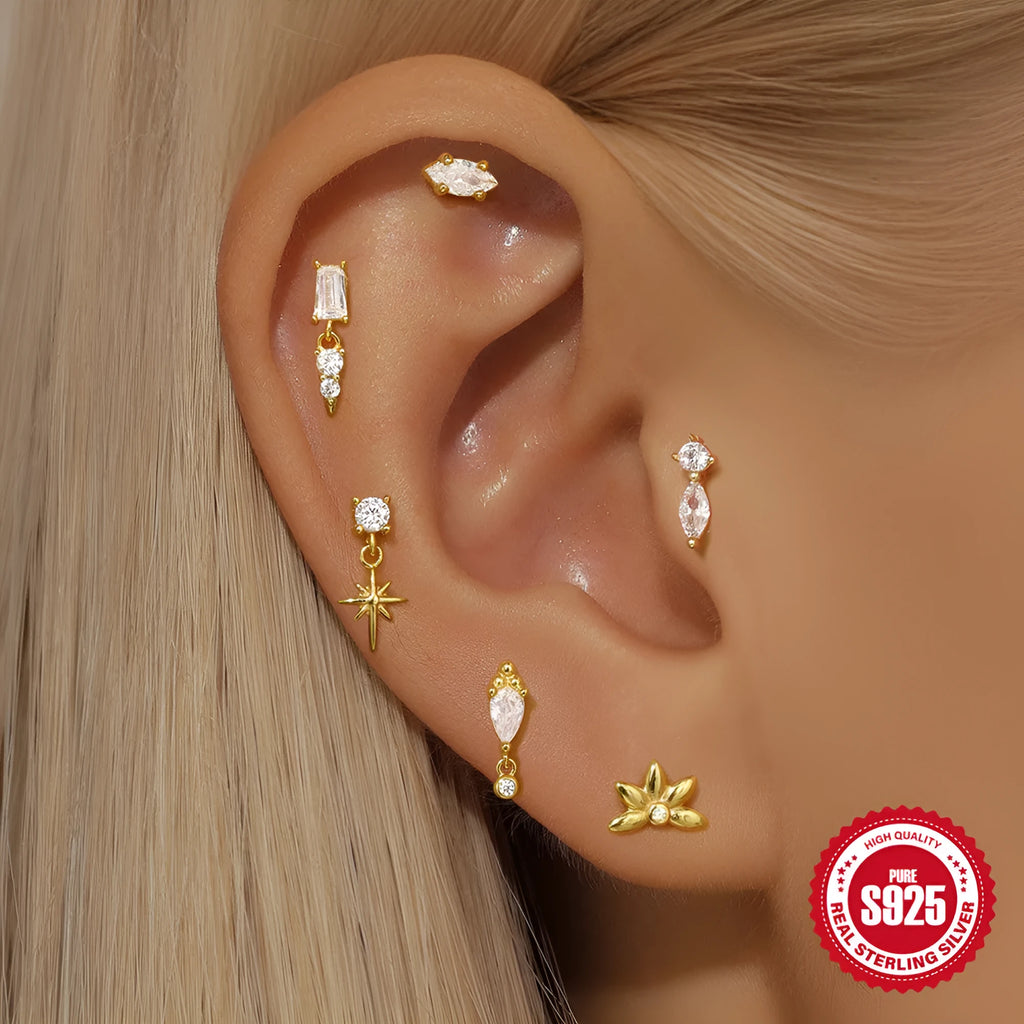 Close-up of a sterling silver ear stud with a gold-toned tassel inlay design.