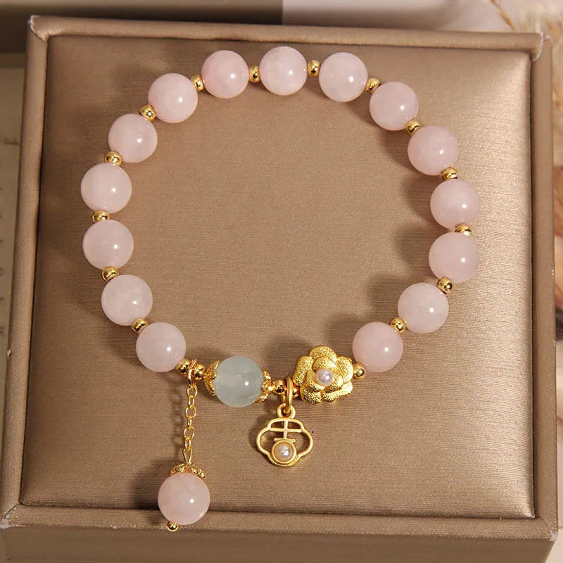 Close-up of a women's pink crystal flower bracelet on an adjustable chain.