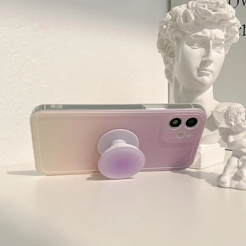 Yellow and purple gradient silicone iPhone case with a retractable viewing stand extended.