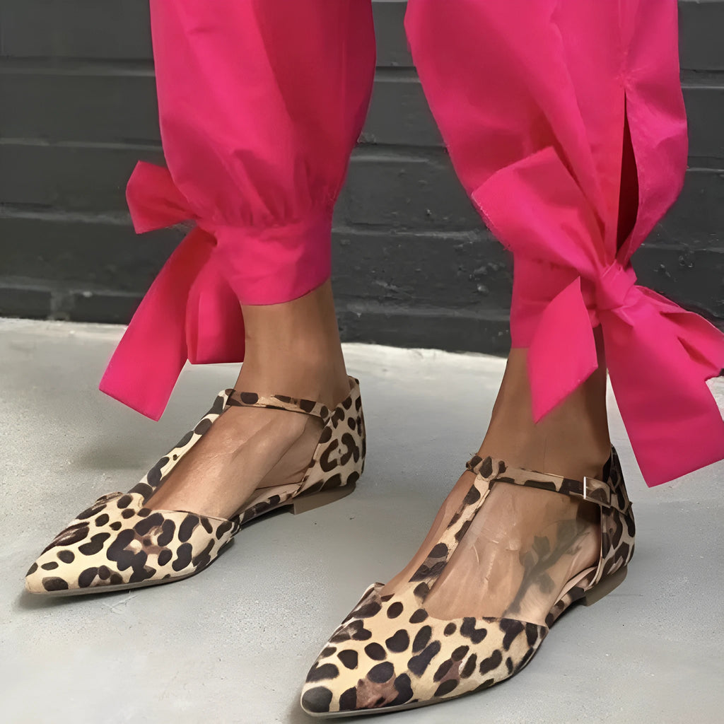 Women's leopard print pointed toe pumps with a short chunky heel and ankle strap.
