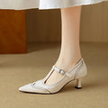Women's black high heel pump with vintage skull engraving and stiletto heel.