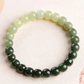 Natural Hetian jade bracelet showing gradient clear to water colour beads on elastic cord
