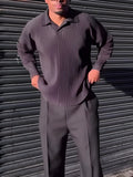 Black men's long-sleeved casual top with a pleated front detail, shown in a regular fit.