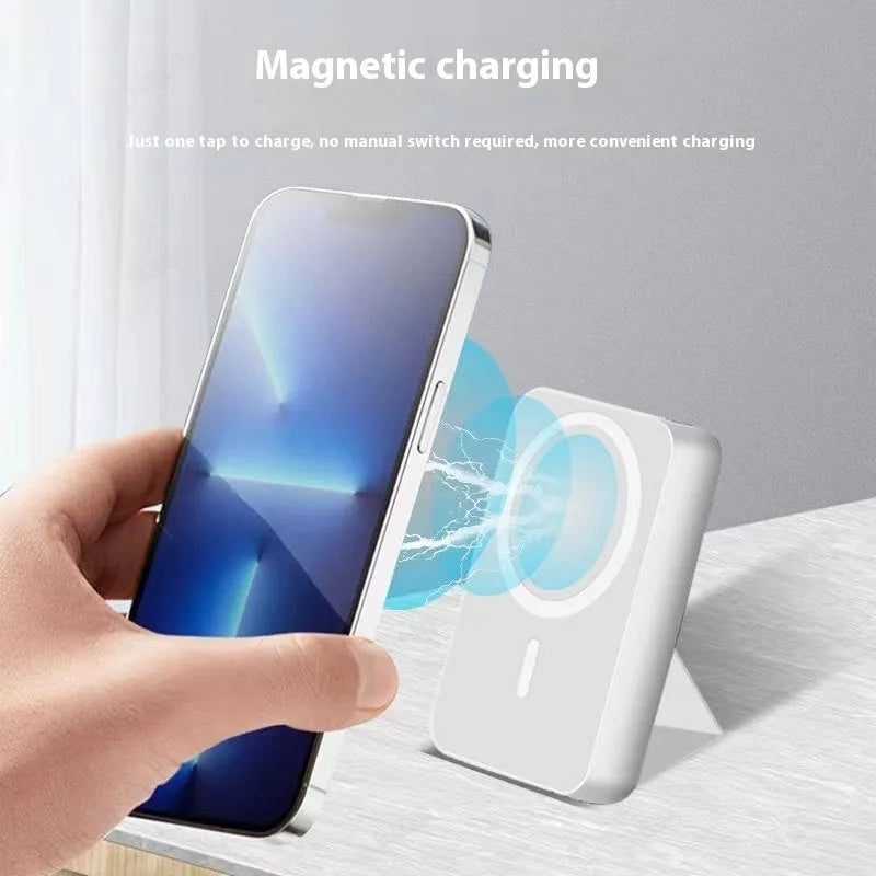 Folding bracket magnetic suction power bank 10000 MA in black plastic shell with phone attached showing stand mode