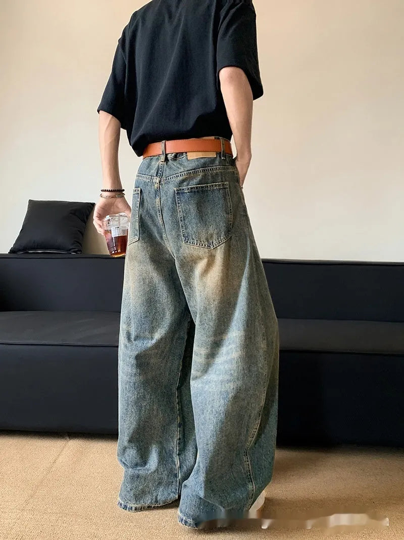 Retro blue distressed men's jeans with wide leg fit and micro elastic cotton blend fabric
