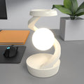 Rotating moon desk lamp with wireless charger in grey on a bedside table