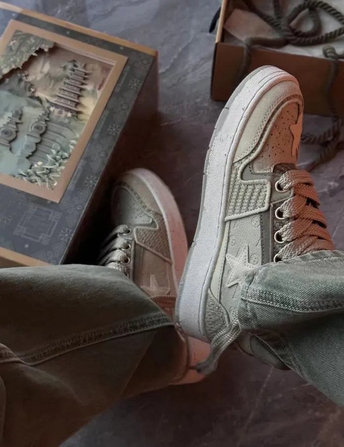 Green star print low-top casual sneakers with a lace-up front and thick rubber sole.