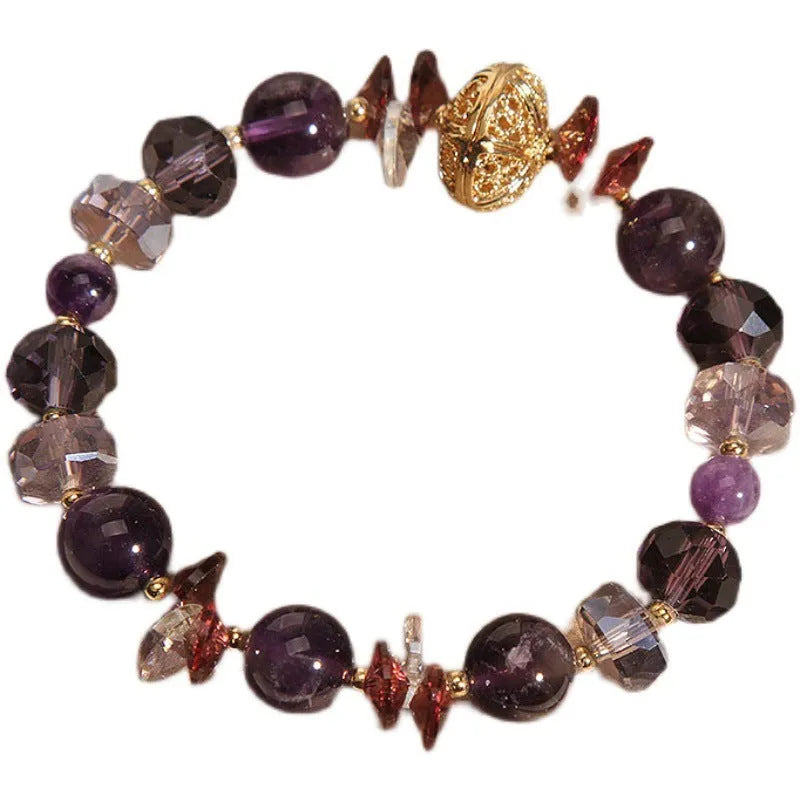 Purple crystal bracelet with pumpkin beads, wind chime motifs, and rhinestone decorations on adjustable band