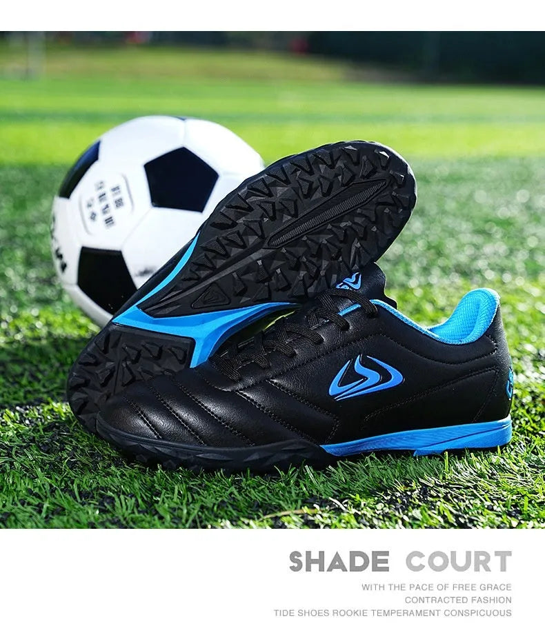 Low top football shoes with synthetic leather upper and rubber sole in black and white broken nails colour.