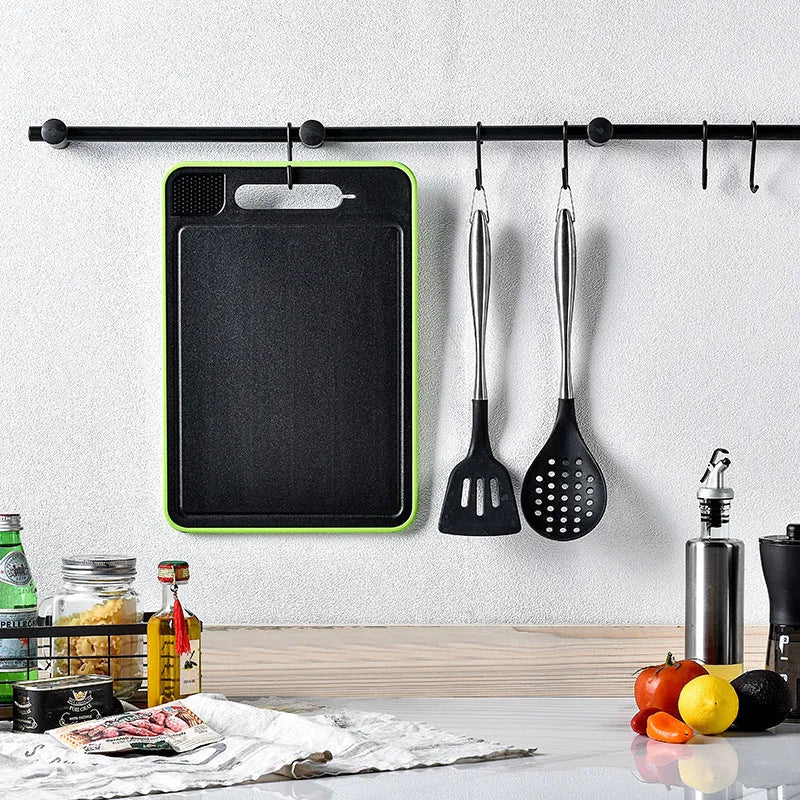 Square grey aluminium cutting board with double-sided design showing grinding teeth and integrated knife sharpener